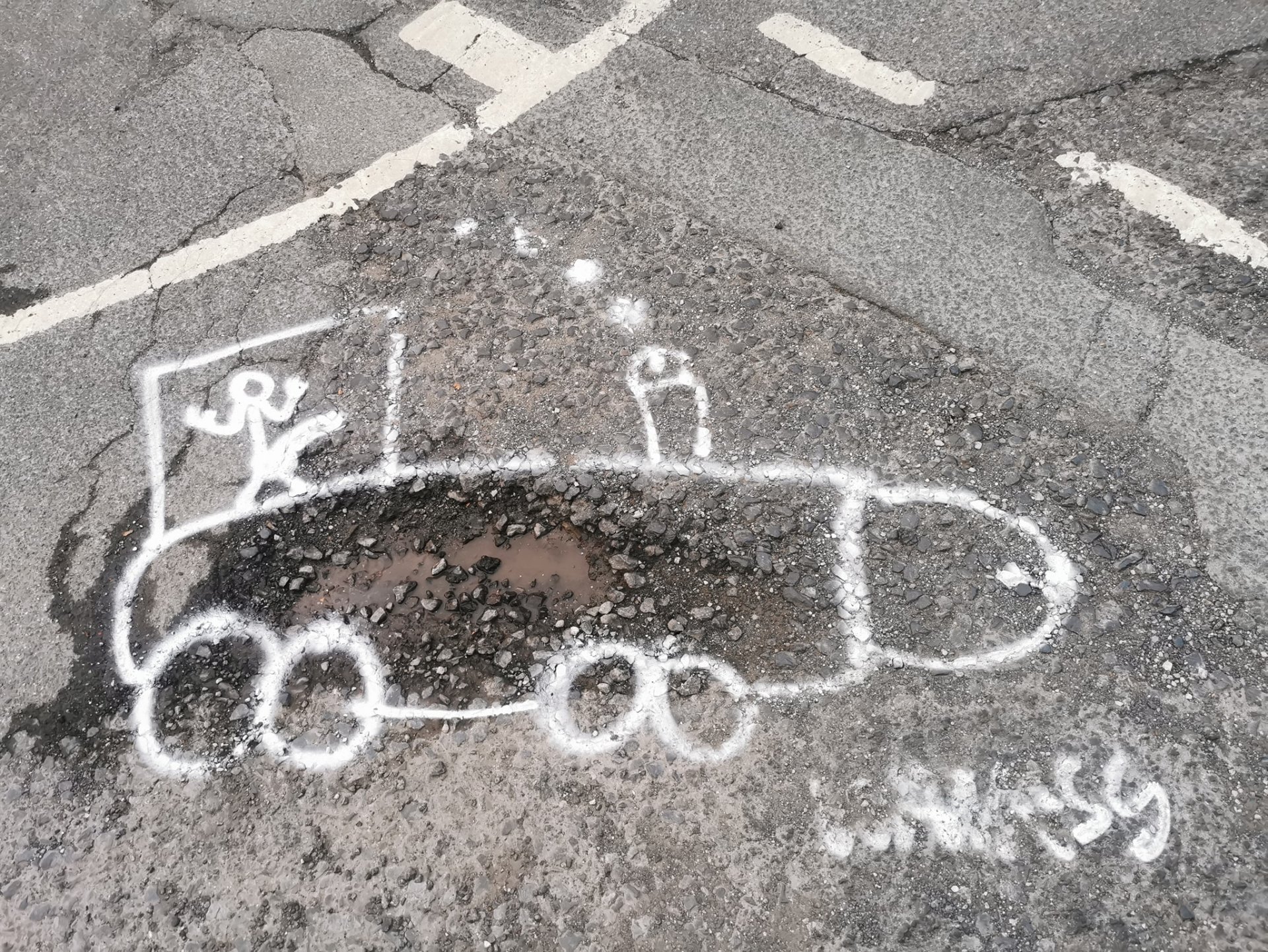 Wanksy graffitiing giant penises on to potholes so that the council