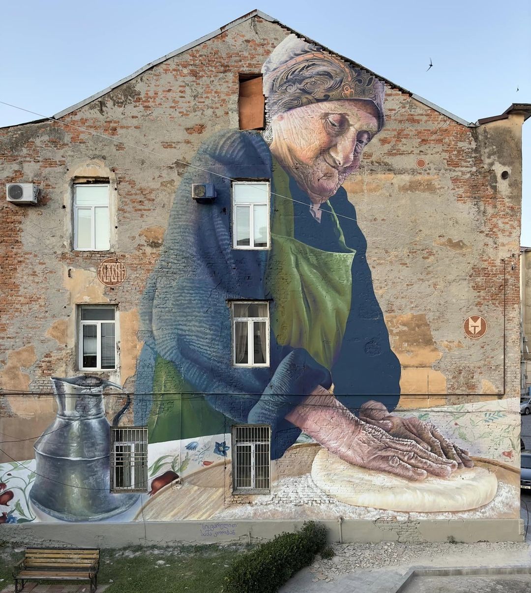 Old woman bakes bread by Sasha Korban in Kutaisi, Georgia